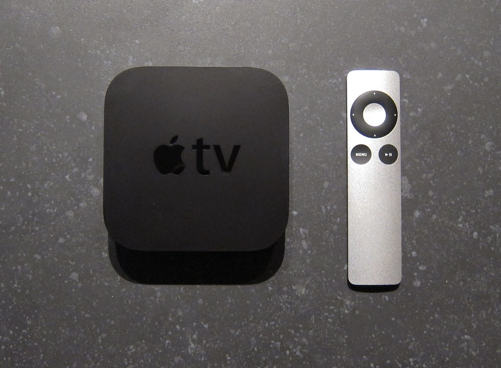 Apple TV 4K remote on living room table in Malaysia; setup guide for US apps with NordVPN